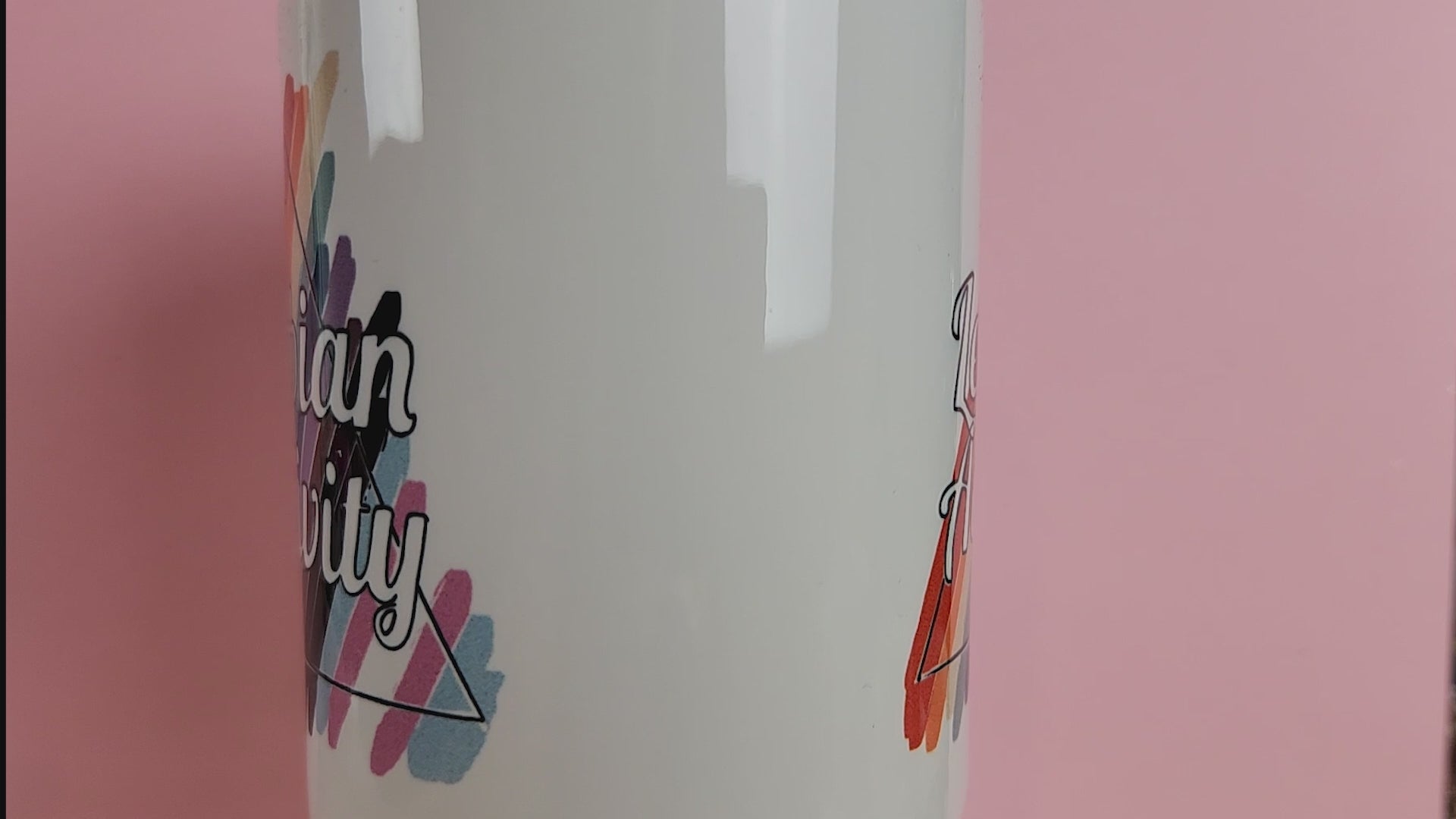 Video of LGBTQ mug reads Lesbian Activity over progress pride colors. Cute lesbian mug on pink background
