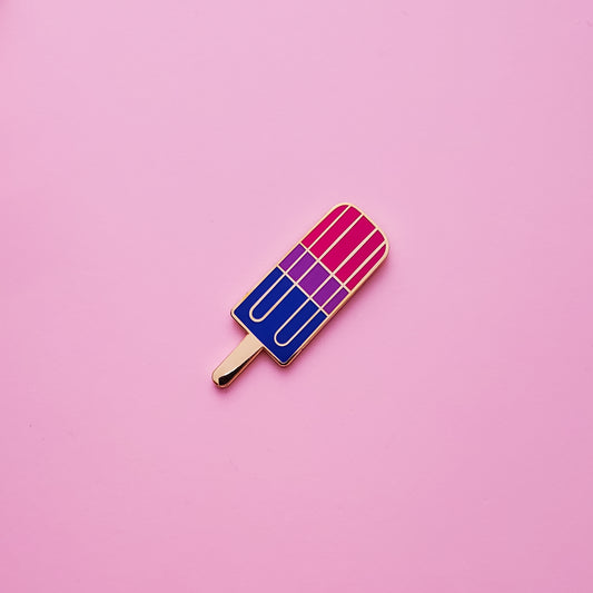 Bisexual Pride Popsicle Pin on a pink background. Pin is has vibrant bisexual pride colours set in a polished nickle metal. Bisexual pride pin colours are pink, purple and blue.Bisexual Popsicle Pin - LGBTQ Pins Canada | Little Rainbow Paper Co